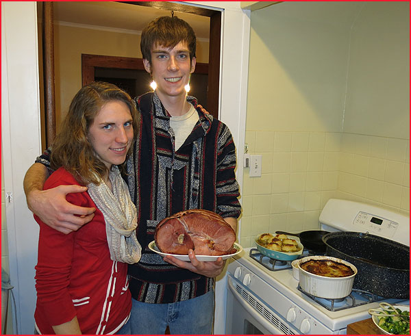 Charles with his sous chef Emma. This is as close as she got to the ham! Nice glowing, electric earrings she gave Charles for  Christmas!